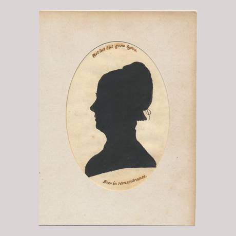 
        Front of silhouette with woman looking left, in card frame.